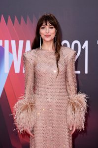 Dakota Johnson at the premiere in a Gucci golden dress