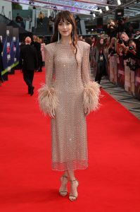 Dakota Johnson at the premiere in a Gucci golden dress