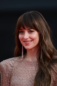 Dakota Johnson at the premiere in a Gucci golden dress